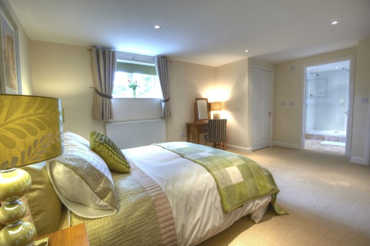 A bedroom with a bed and a dresser.