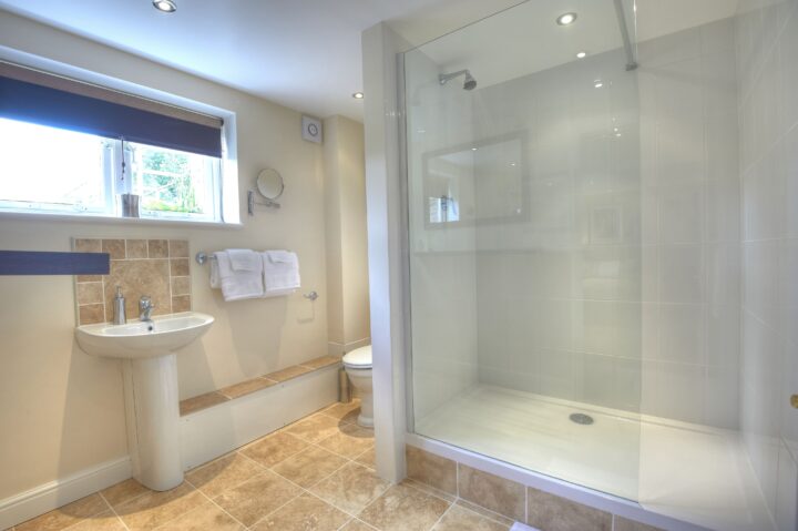 A bathroom with a toilet, sink and shower stall.
