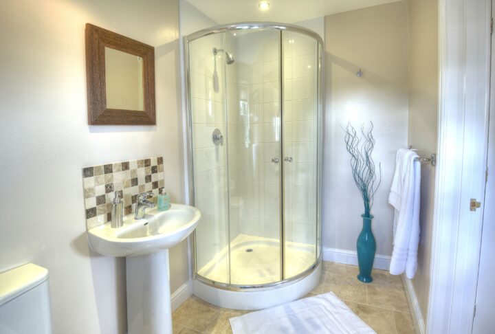 A white bathroom with a glass shower stall.