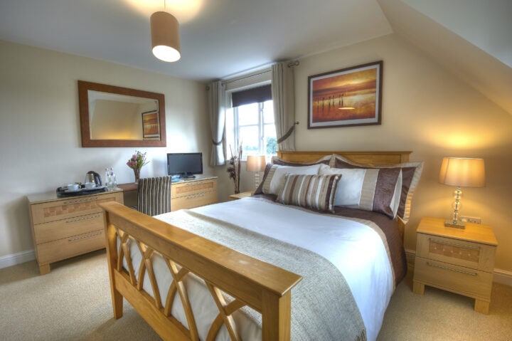A bedroom with a bed and a dresser.