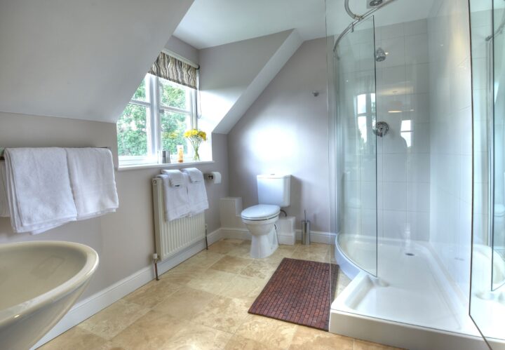 A bathroom with a shower, sink and toilet.