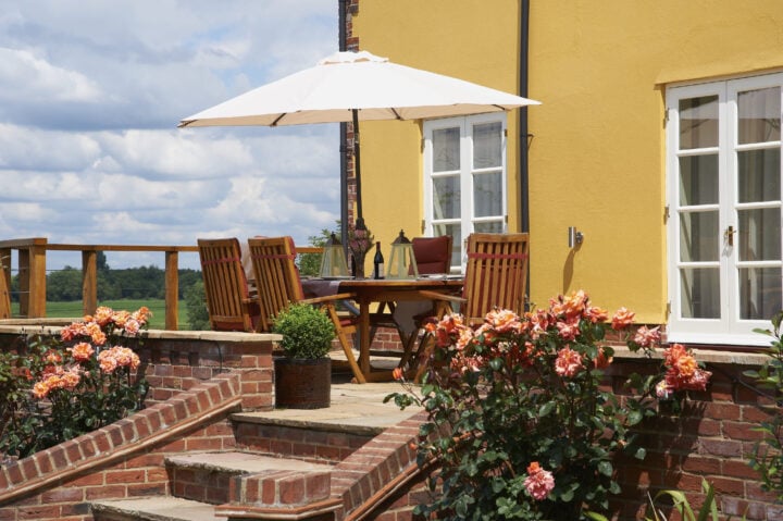 A wooden deck with a table and chairs.
